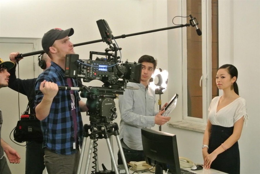 Camera crew filming against Beijing cityscape